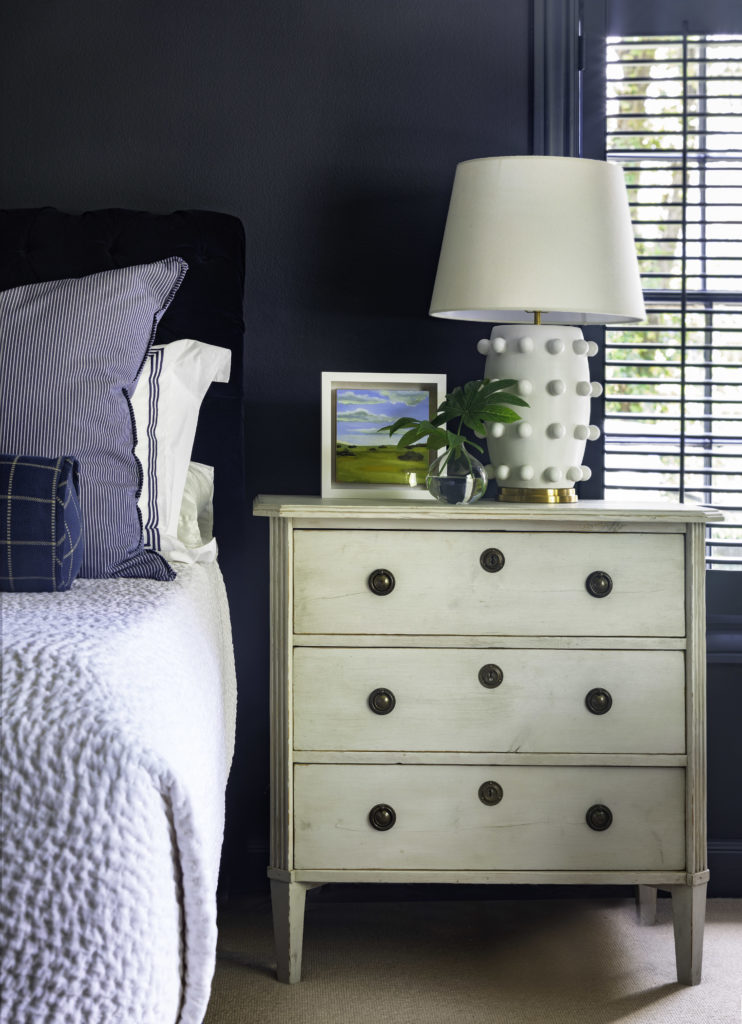 Hale Navy by Benjamin Moore, Lone Ranger Antiques cabinet, Kelly Wearstler Linden 26 Inch Table Lamp by Visual Comfort and Co., Lam Bespoke plant, Pindler & Pindler Bellagio Midnight Fabric,  Matouk Bel Tempo, John Robshaw Handstiched White Coverlet, Perennials 805-90 blue and white stripe